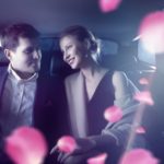 車内で男女が微笑み合っている画像